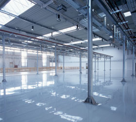 "The inside of a large and empty modern storehouse"